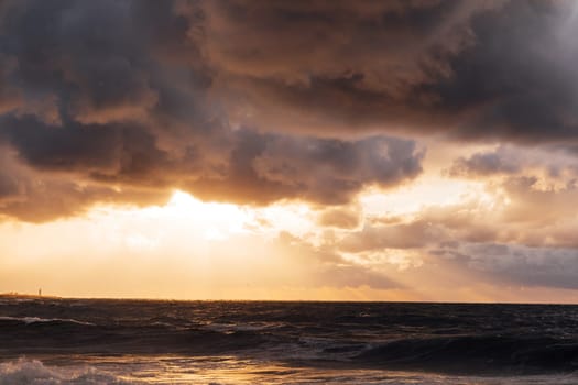 landscape, storm on the sea and sunset sky with clouds