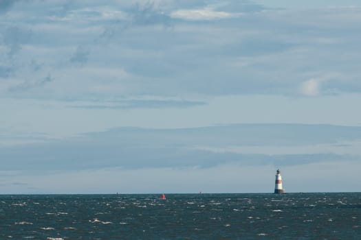 Lighthouse on the sea at sunny day - horizontal shot