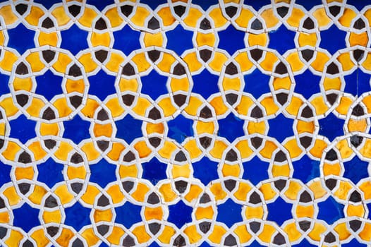 yellow and blue ceramic tiles with an abstract geometric pattern. Background with oriental arabic ornament