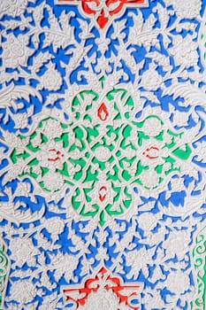colorful carved wooden painted background with traditional Uzbek ornaments and oriental patterns in Tashkent in Uzbekistan