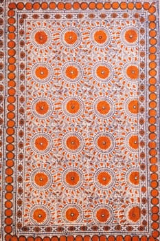 traditional Uzbek geometric pattern on an ancient vintage carpet in Uzbekistan. Oriental background with beautiful ornaments