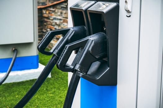 charging cable at energy electric charging station for charge electric automobiles close-up