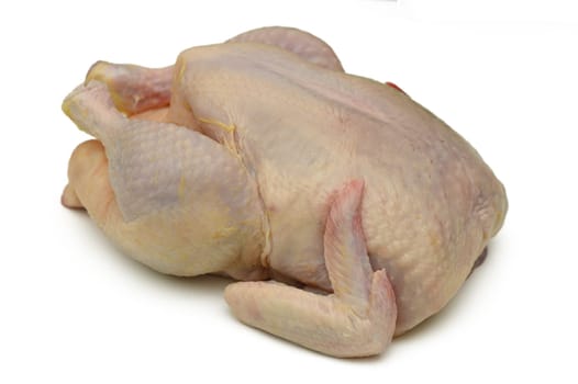 A whole chicken rests on a clean surface, showcasing its plumpness and freshness, inviting chefs to craft delicious meals during a vibrant evening with loved ones.
