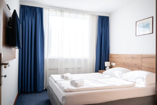 A modern and serene hotel room in a medical rehabilitation facility, designed for comfort and relaxation, offering a peaceful environment for patients to recover and rejuvenate.