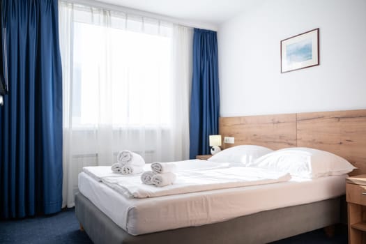 A modern and serene hotel room in a medical rehabilitation facility, designed for comfort and relaxation, offering a peaceful environment for patients to recover and rejuvenate.