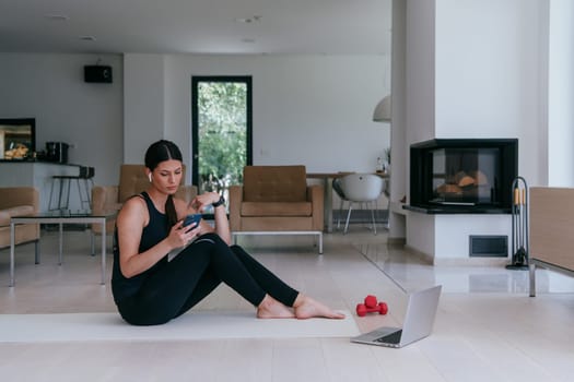 Young Beautiful Female Woman with Trainer via Video Call Conference in Bright Sunny House. Healthy Lifestyle, Wellbeing and Mindfulness Concept.