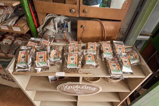 Crete.Greece - april 02, 2025: Coffee bags displayed on wooden shelves with Greek labels reading and priced at 3.80, reflecting a rustic and authentic store atmosphere.