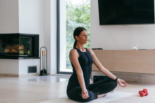 Young Beautiful Female Exercising, Stretching and Practising Yoga with Trainer via Video Call Conference in Bright Sunny House. Healthy Lifestyle, Wellbeing and Mindfulness Concept