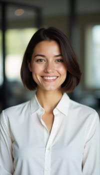 In a bright office space, a confident brunette woman exudes warmth as she smiles, engaged in customer service at a busy bank. Her friendly demeanor enhances the welcoming atmosphere.