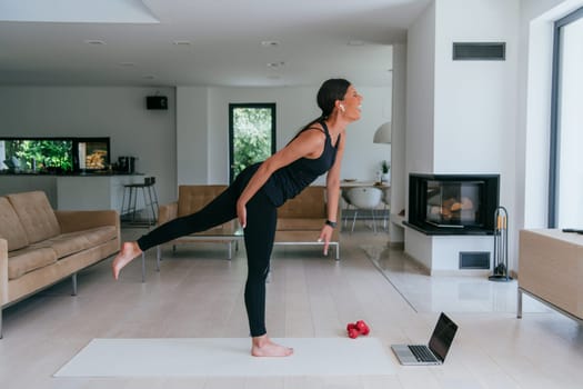 Young Beautiful Female Exercising, Stretching and Practising Yoga with Trainer via Video Call Conference in Bright Sunny House. Healthy Lifestyle, Wellbeing and Mindfulness Concept.