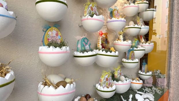28.03.2025 Innsbruck: Colorful Easter Decorations Featuring Eggs and Baskets on Display in Store Window. Easter-themed decorations showcasing intricately designed eggs and baskets arranged for a festive window display, radiating holiday cheer and vibrant colors, creating a delightful seasonal atmosphere.
