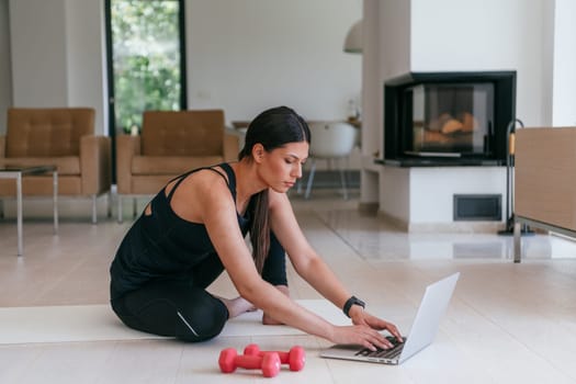 Young Beautiful Female Exercising, Stretching and Practising Yoga with Trainer via Video Call Conference in Bright Sunny House. Healthy Lifestyle, Wellbeing and Mindfulness Concept
