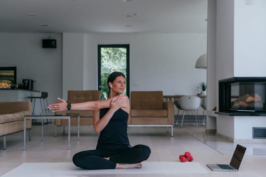 Young Beautiful Female Exercising, Stretching and Practising Yoga with Trainer via Video Call Conference in Bright Sunny House. Healthy Lifestyle, Wellbeing and Mindfulness Concept.