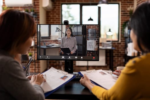 HR women representatives in a virtual meeting, exchanging notes about different job applicants. Female asian team leader on video call, leading a discussion with her team in recruitment agency.