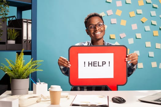 Smiling recruiter presenting a hiring message bubble, inviting job seekers to apply for position. Enthusiastic man holding a help signboard, promoting employment opportunities.