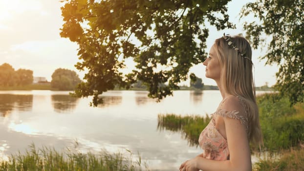 Beautiful young blond woman outdoors portrait near the lake