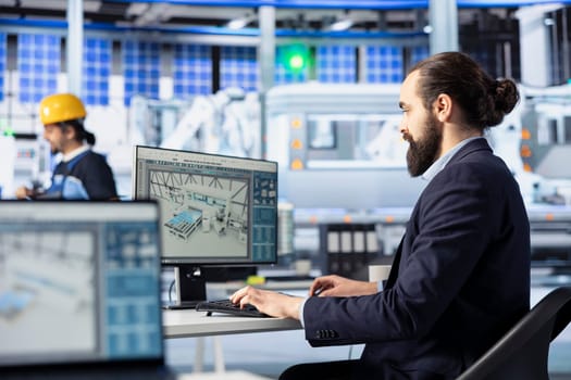 Photovoltaics factory engineer creating CAD models and technical drawings for solar modules. Employee developing and optimizing solar panel designs for efficiency and manufacturability