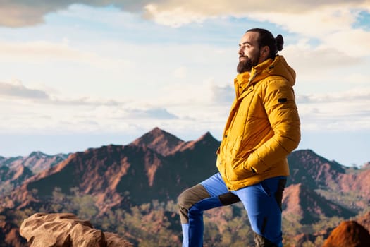 Traveler alone in the high altitude wilderness admiring the breathtaking scenery, enjoying fresh air and stunning mountain top landscape. Peaceful atmosphere inspire mindfulness.