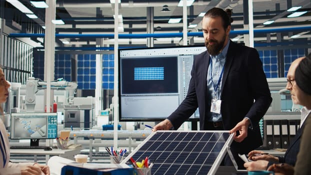 Research and development team analyzes solar cell prototypes to optimize energy conversion rates. Solar panels plant experts developing innovative manufacturing techniques, camera A