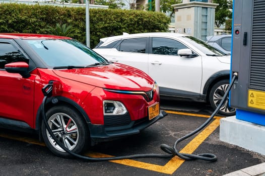 Modern Vietnamese electric cars Vinfast at a charging station on the street in Vietnam. Nha Trang, Vietnam - April 01, 2025