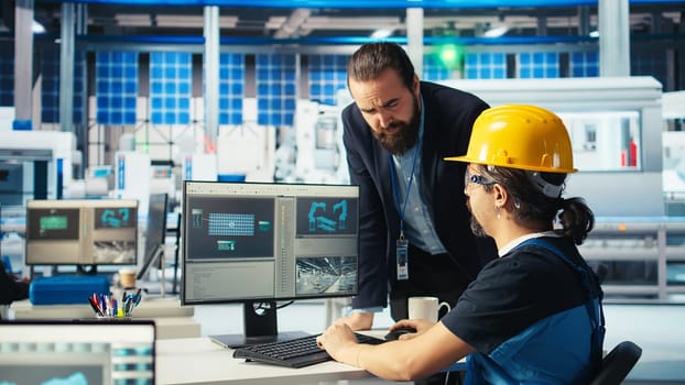 Photovoltaics factory manager showing engineer fixes to be made to repair malfunctioning systems. Man showing solar panels manufacturing plant technician upgrades needed to reduce downtime, camera A