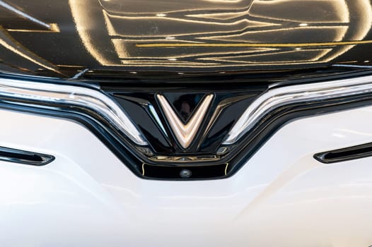 Vinfast logo on the hood of modern Vietnamese Vinfast VF8 electric car at automobile exhibition close-up. Nha Trang, Vietnam - April 01, 2025