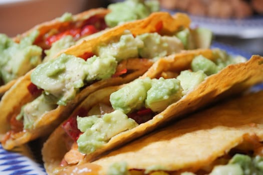 Colorful tacos with guacamole and fresh toppings are ready to enjoy.
