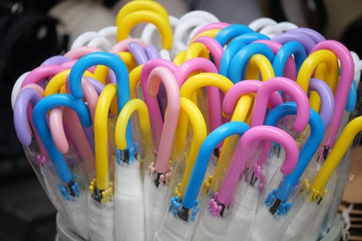 Brightly colored umbrellas showcase their unique designs in a market.
