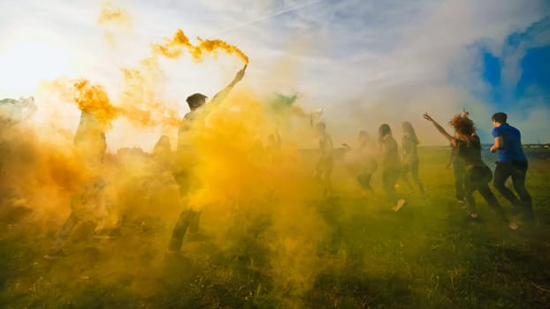 Happy friends girls waving colorful smoke at sunset