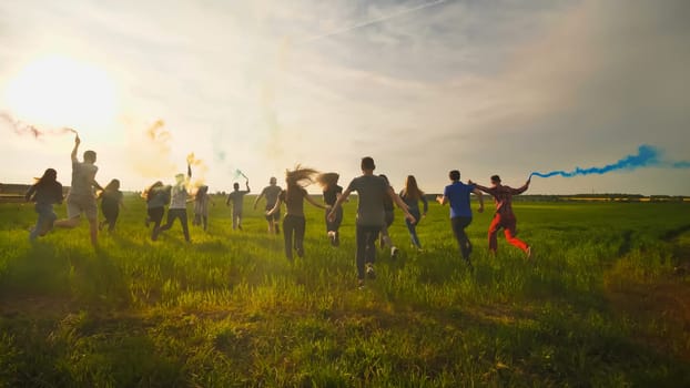 Happy friendly friends run across the field with toy planes that emit colored smoke
