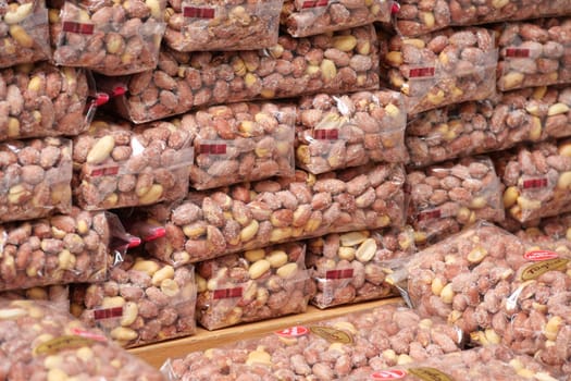 Various bags of nuts neatly stacked in a local market aisle