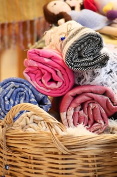 Brightly colored rolled textiles and handcrafted dolls display craftsmanship.