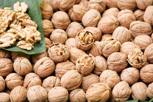 Walnuts are arranged with their shells, creating a rustic market display.