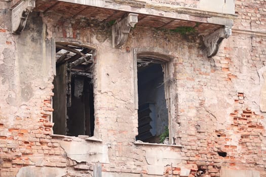 Cracked walls and empty windows reveal the history of an abandoned structure