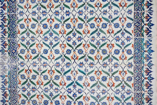Intricate tilework features vibrant floral motifs and geometric shapes.