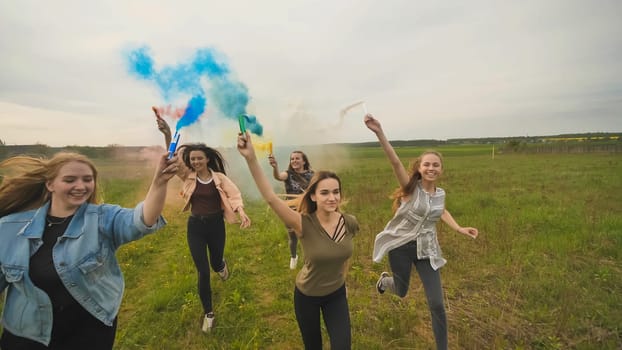 Happy friendly friends are running with toy planes that emit colored smoke