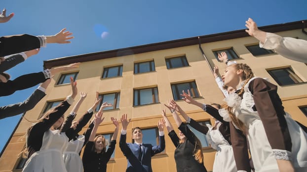 Happy graduates join hands together. The concept of graduation