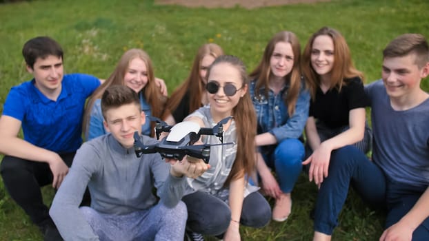 Happy cheerfulfriends launch a drone from their hands