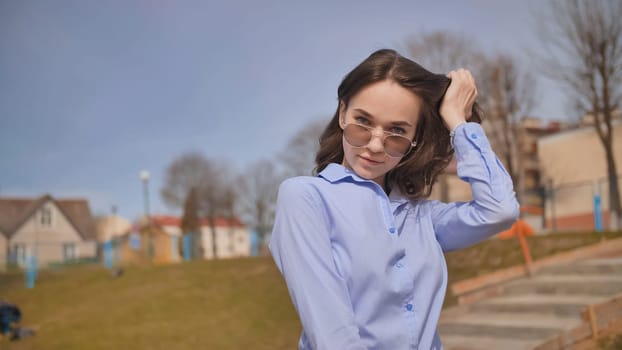 Beautiful 17 year old girl posing outdoors against the blue sky