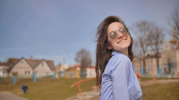 Beautiful 17 year old girl posing outdoors against the blue sky