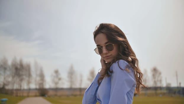 Beautiful 17 year old girl posing outdoors against the blue sky
