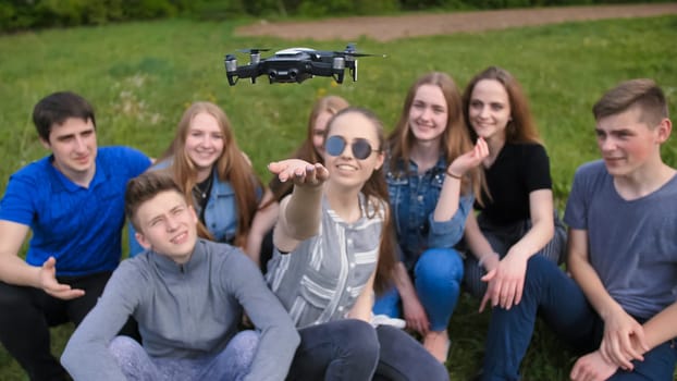 Happy cheerfulfriends launch a drone from their hands