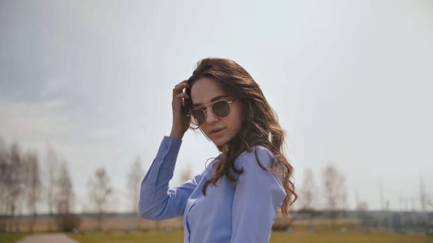 Beautiful 17 year old girl posing outdoors against the blue sky