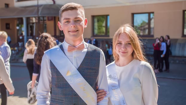 Russian schoolchildren graduates posing on the day of graduation