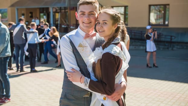 Russian schoolchildren graduates posing on the day of graduation