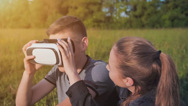 Girl and guy in virtual glasses in a city park