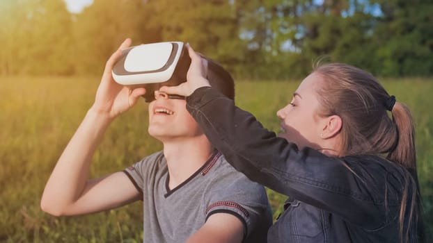Girl and guy in virtual glasses in a city park