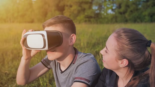 Girl and guy in virtual glasses in a city park