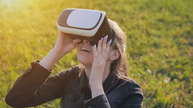 Young girl in virtual glasses in a city park