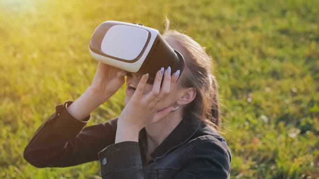 Young girl in virtual glasses in a city park